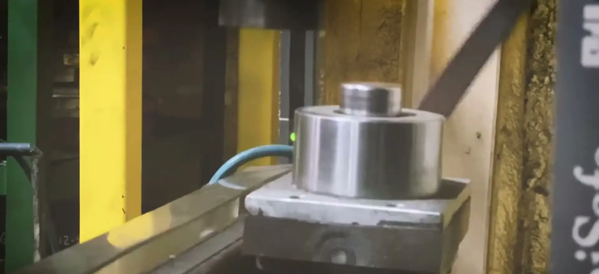 Steel coil stock feeding into a stamping press on the Riverfront Machine floor