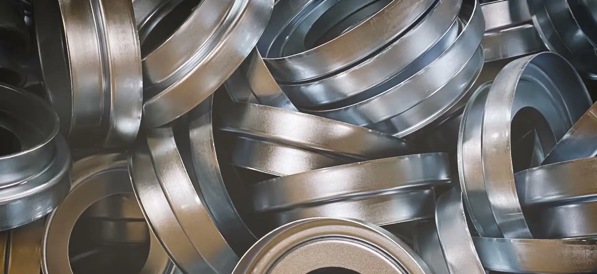 Finished stamped filter end caps stacked after forming at Riverfront Machine